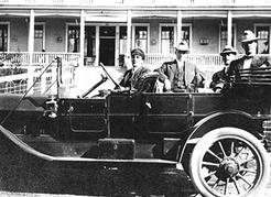 Chauffeur Harry Stevens and guests in the 1912 Mitchell touring car that taxied visitors to and from the Canyon View Hotel, located at the site of today’s Cleveland Dam, ca. 1914. NVMA 6724