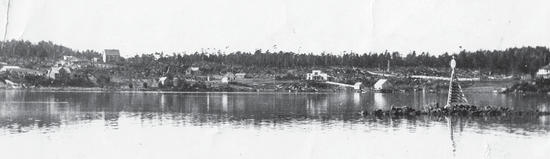 A collection of buildings as seen from a body of water. 