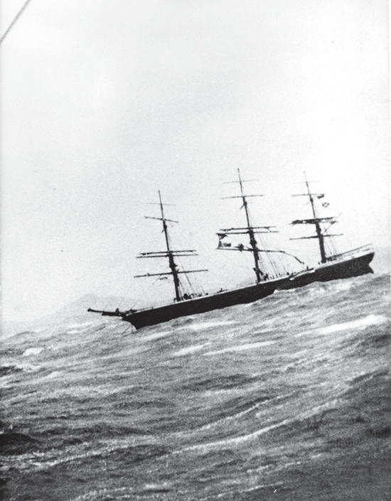 A large sailboat on choppy waters. 