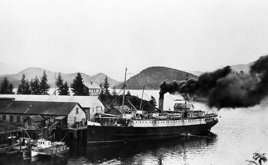 Black smoke emerges from the ship's funnel in this photo while the Maquinna pulls away from the Nootka cannery.