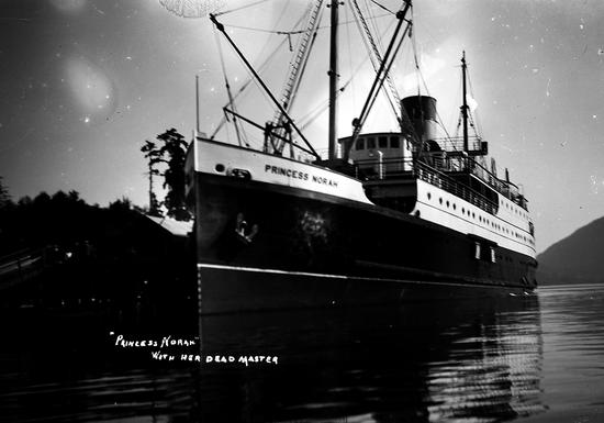 Photograph of The Princess Norah taken from the water looks up at the ship's bow.
