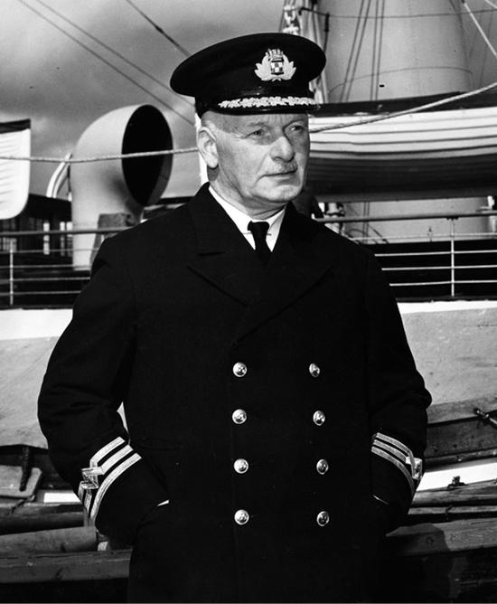 Photo of Captain Red Thompson in his captain’s uniform on the ship. 
