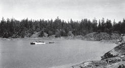 The Caprice in a bay with a smaller boat behind it