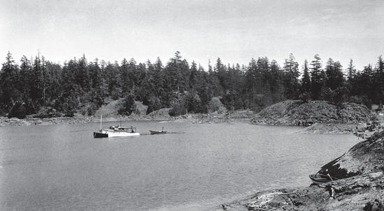 The Caprice in a bay with a smaller boat behind it