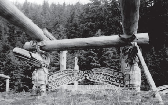 Huge wooden beams in the shape of a longhouse held up by totems of two birdlike animals