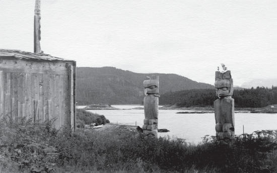 Two large sculptures of birds before a lake