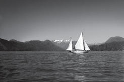 The Caprice next to a large sailboat