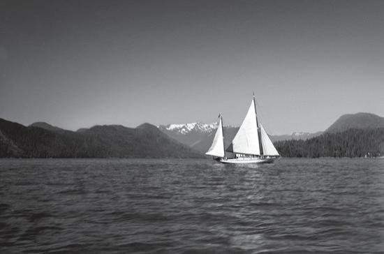 The Caprice next to a large sailboat