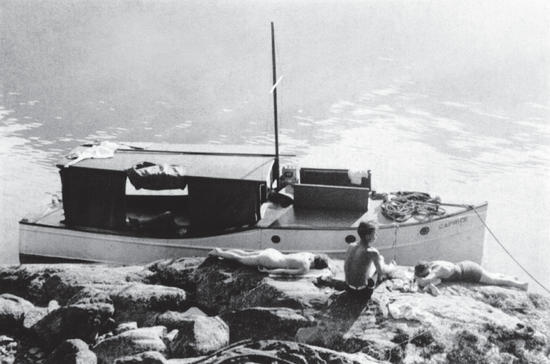 Several of the children lying on a rock as if suntanning