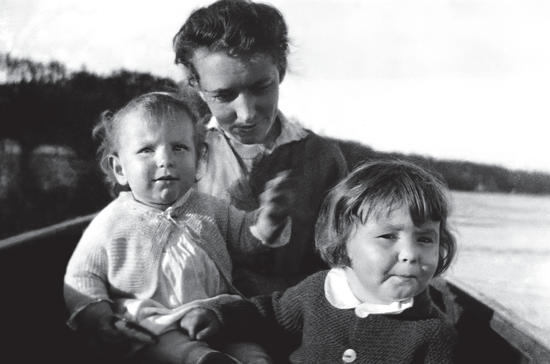 Capi sitting with two of her children