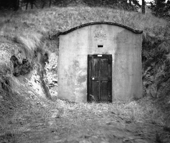 A door leading to a small structure built into a hill.