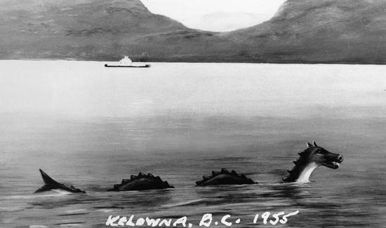 An illustration of a sea serpent in a body of water. In the distance there is a boat followed by hilly land. Text: Kelowna, B.C. 1955