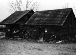 Father Pandosy’s first building was a log chapel with living quarters above. The larger building beside it was a root cellar with walls of parallel logs built four inches apart and packed with earth to insulate the fruits and vegetables stored for the winter. | Kelowna Public Archives 7075