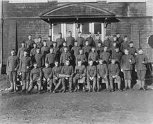 Boys from the Cariboo at Willows Camp in Victoria, holding a Quesnel pennant