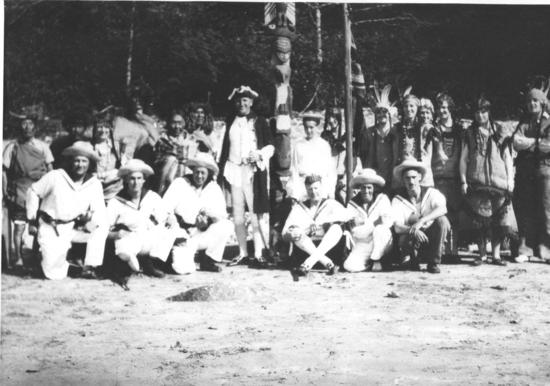 In May 1931, Rowland Brinckman and George Nicholson organized a re-enactment in Tofino of Captain Cook’s 1778 landing in Nootka Sound. Several Tla-o-qui-ahts, including Queen Mary and Chief Joseph, played the parts of Mowachaht people, and a few blonde Norwegian girls also took on aboriginal roles. This “Nootka tribe” greet-ed “Captain Cook,” played by George Nicholson, welcoming him and his men ashore.