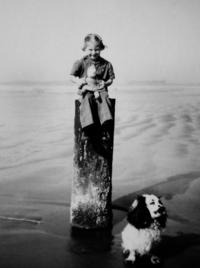 Fran Aitkens atop a piling on Long Beach in the late 1940s. Placed there in long lines to deter landing craft and airplanes in case of Japanese invasion during World War II, some pilings can still be seen at low tide on the beaches.