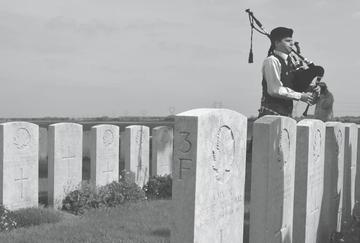 SFU piper Kevin McLean plays at James Richardson’s grave in France.