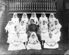 Red Cross volunteers pose with a French lieutenant for a funds campaign.